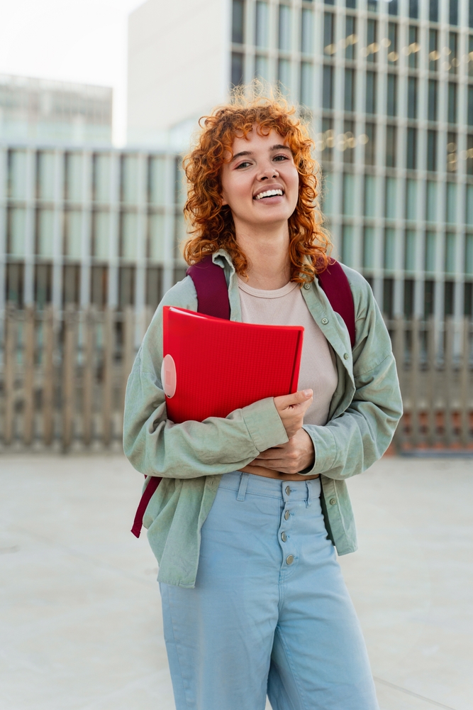 University,Student,Portrait,Of,Red-haired,Girl,Looking,At,The,Camera
